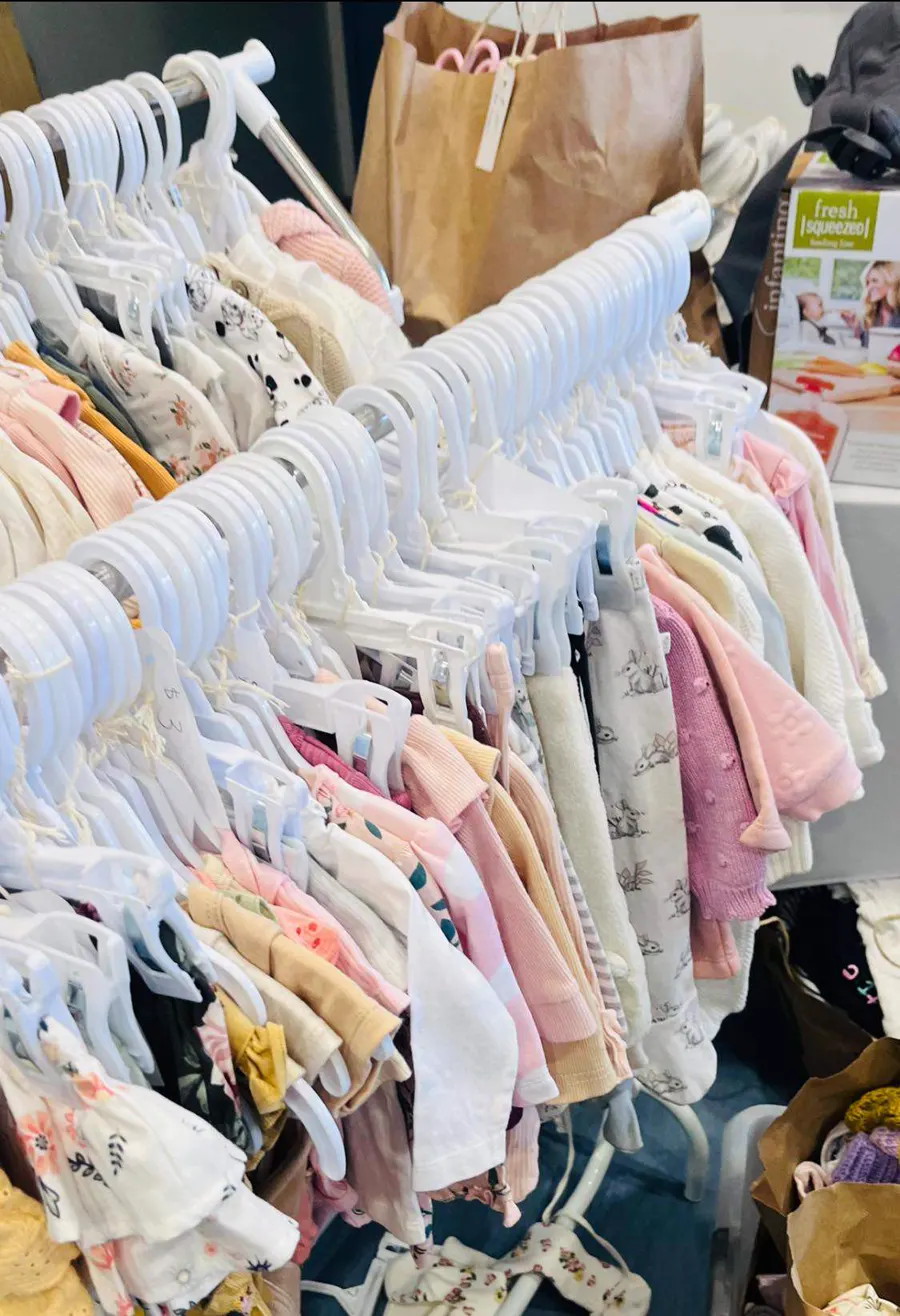 Racks of children's clothing at the Relove Recycle Kids Market